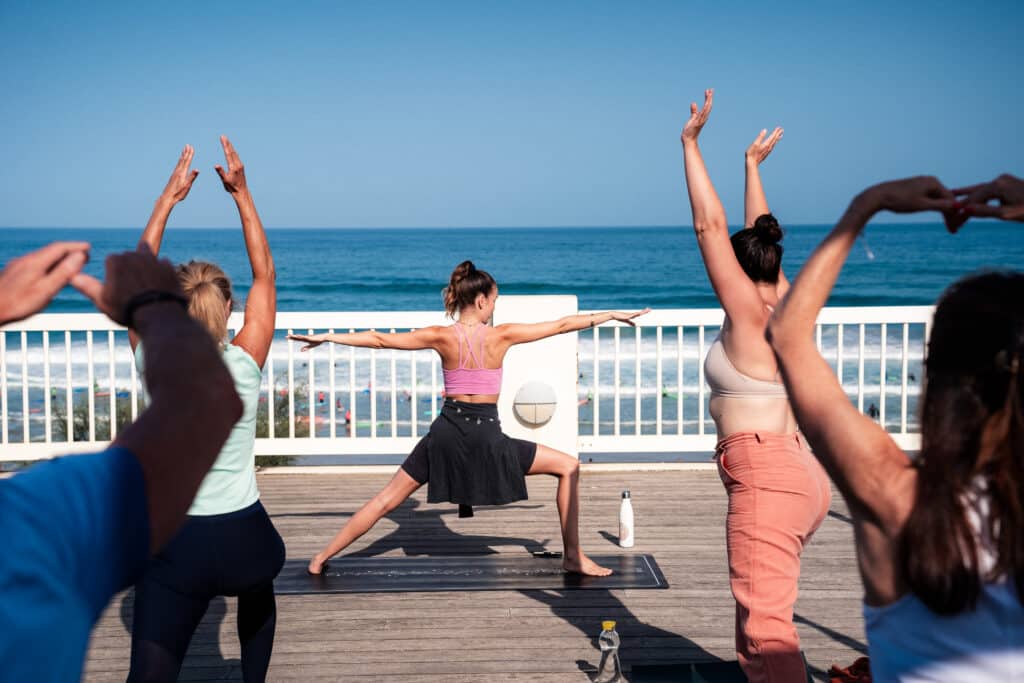 Séance de yoga relaxante sur le toit de l'Espace de l'Océan à Anglet, face aux vagues